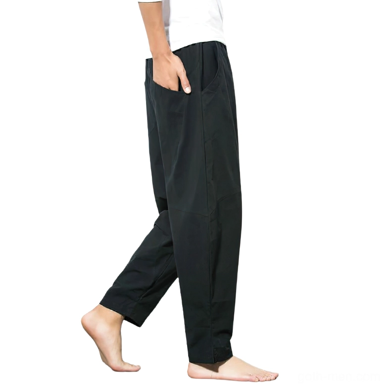 Black harem pants side profile showing ankle taper and side pocket detail