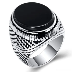 Black stone gothic signet ring for men - vintage embossed band pattern, oblique front view on white background