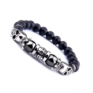 Gothic black onyx skull bracelet side angle view - displaying elastic stretch band and antique silver hardware detail
