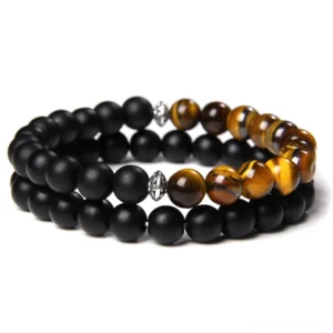 Black onyx and tiger's eye beaded gothic bracelet set, dual-layer design with metal accents, flat lay photography