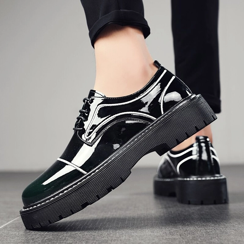 Men wearing black patent leather oxford platform shoes, side perspective with matching dark pants
