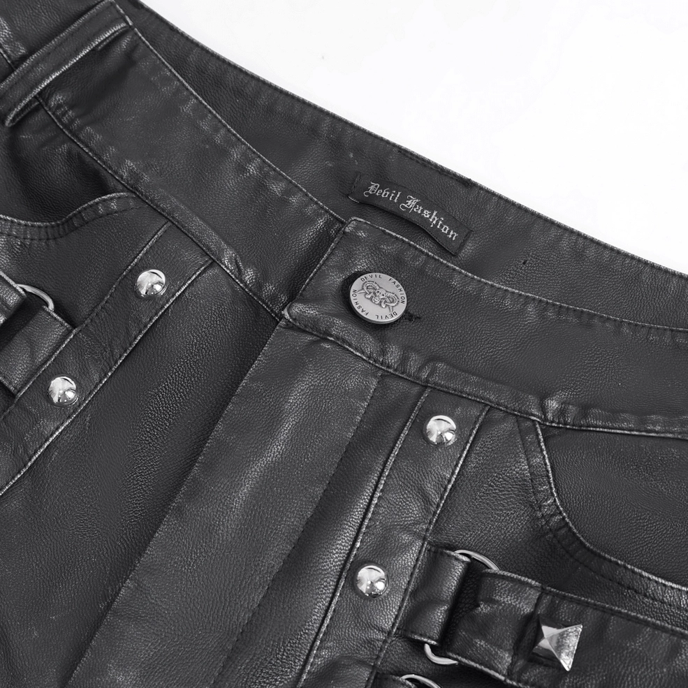 Close-up detail of black leather pants waistband featuring metal button, brand label, and strap buckle hardware