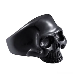 Black stainless steel skull signet ring with high-polished mirror finish, three-quarter side view showcasing anatomical detail and gothic design