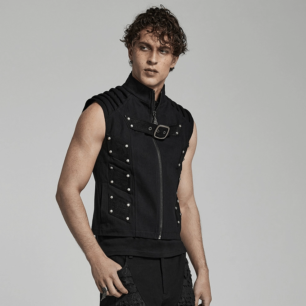 Black studded punk gothic vest detail shot on model, highlighting texture contrast between twill fabric and faux leather patch elements