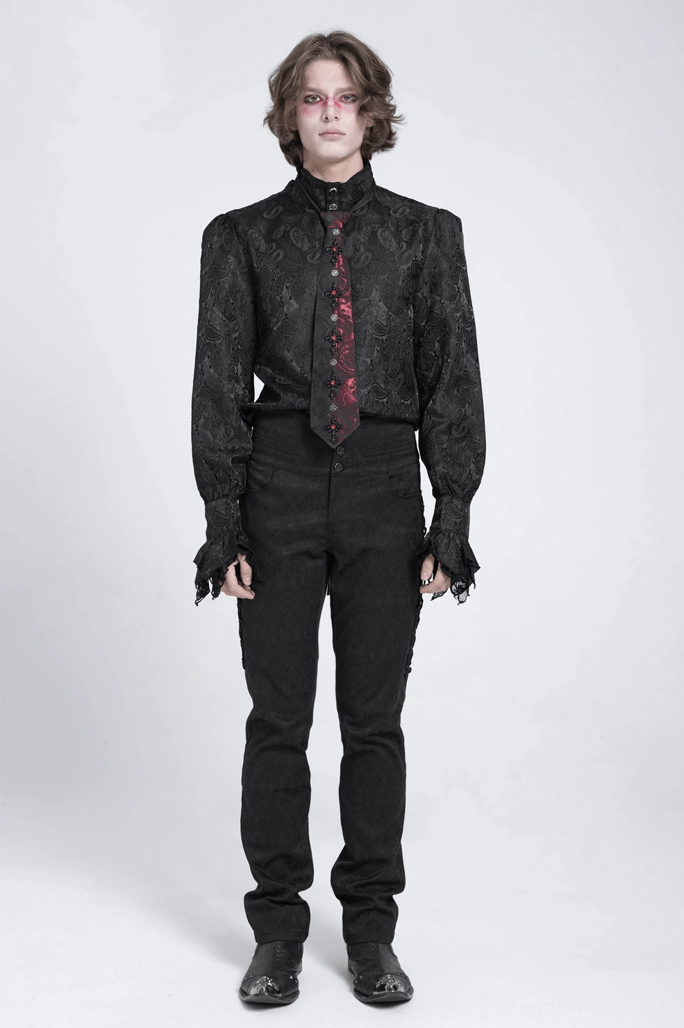 Black and red gothic necktie on male model, three-quarter view showing formal alternative fashion styling