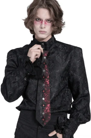 Male model wearing black and red rose gothic crystal cross necktie with red gothic eye makeup, front full-body view on white studio background