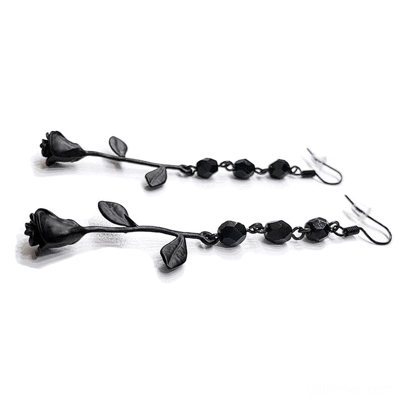 Two pairs of black rose dangle earrings with beaded chain detail, top-down flat lay view showing fishhook ear wires