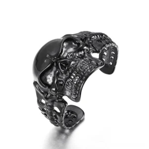 Black skull open cuff bracelet front oblique view showcasing detailed 3D carved skull design in stainless steel