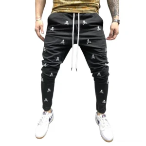 Black gothic skull lace-up pencil pants with drawstring waist, worn by male model showing front profile against studio background