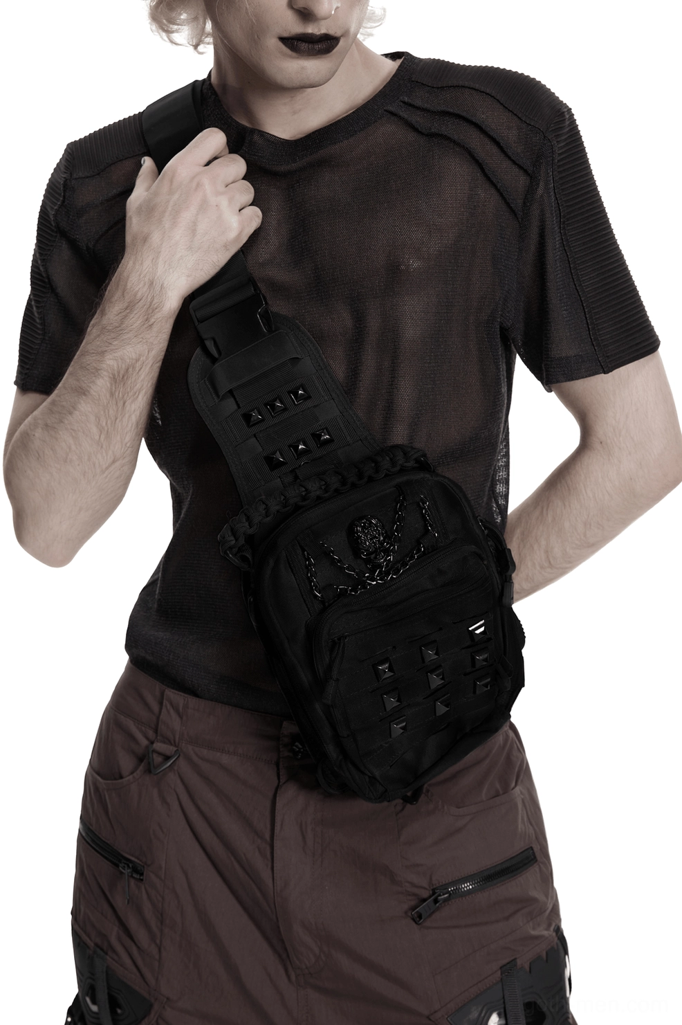 Black skull studded gothic crossbody backpack front view on male model wearing hooded goth outfit