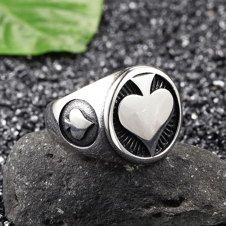 Black gothic spade ring embossed design, radial textured surface detail on white