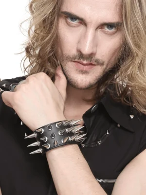 Male goth model showcasing wide black leather spiked bracelet with silver spike details close-up