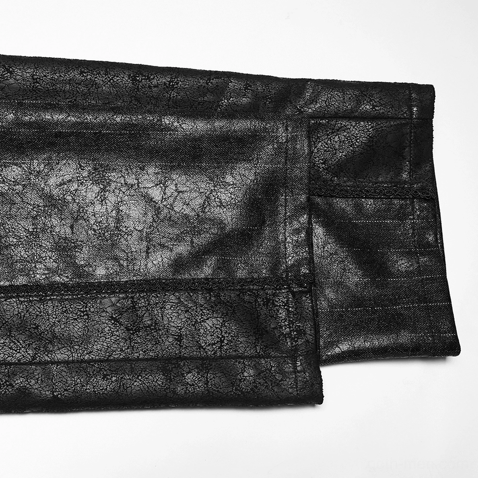 Close-up textile detail of cracked faux leather with stitched seams on black steampunk pants