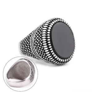 Men's black stone signet ring side profile showing inner ring details and dotted embossed texture