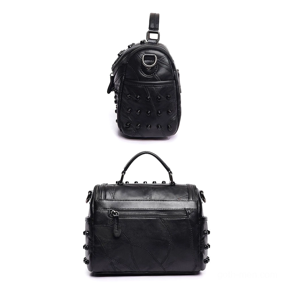 Mini vertical black studded messenger bag front top view showing all-over metal studs and top loop strap