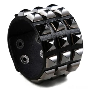 Black studded leather gothic cuff bracelet with silver pyramid studs and snap closure - front oblique view