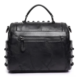 Black leather crossbody bag rear flat view with exterior zipper pocket and patchwork leather detail
