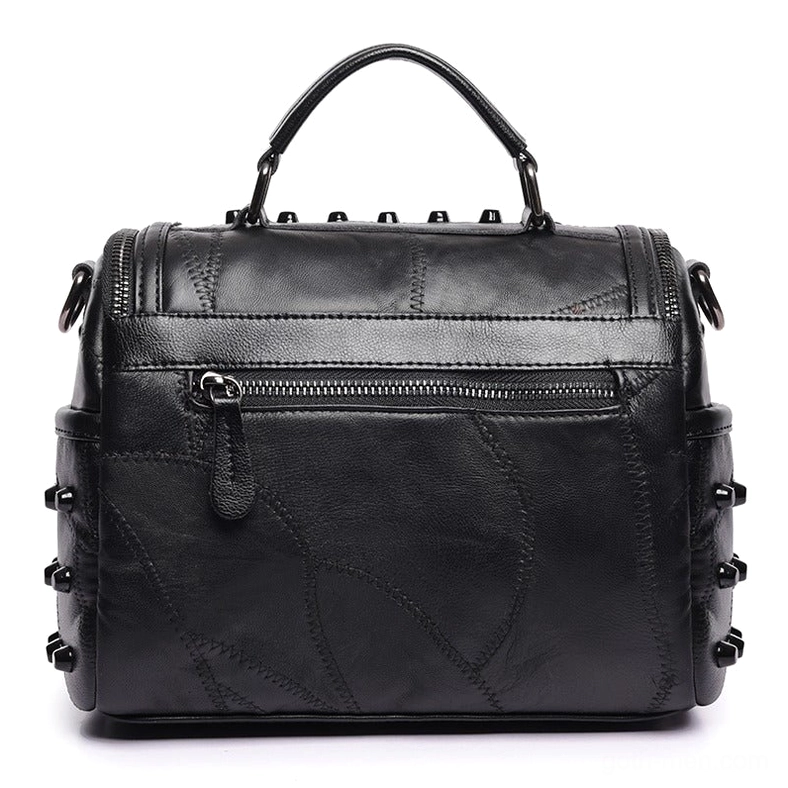Black leather crossbody bag rear flat view with exterior zipper pocket and patchwork leather detail