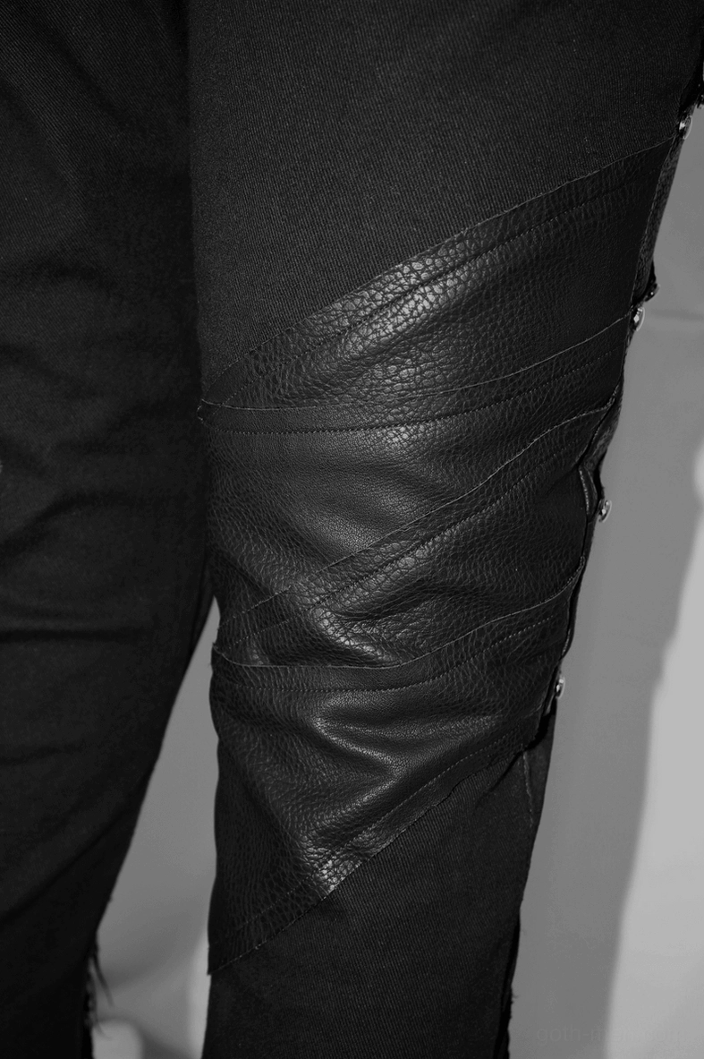 Lower leg detail of black punk gothic trousers showing frayed hem and ankle opening