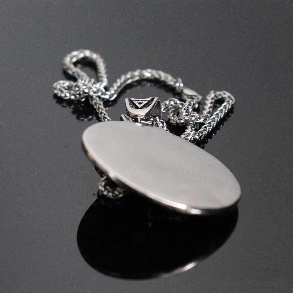 Back side of Black Sun Wolf amulet pendant showing polished smooth silver finish with reverse design detail and chain attachment point
