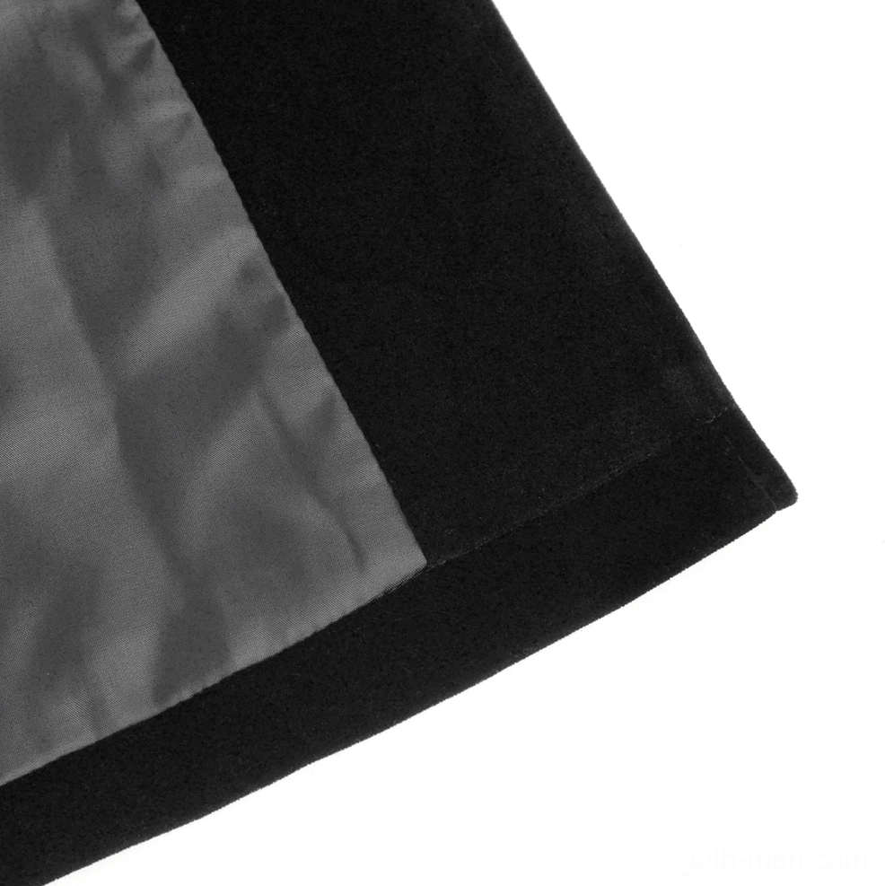 Black velvet tailcoat extended back train hem showing length and theatrical silhouette movement