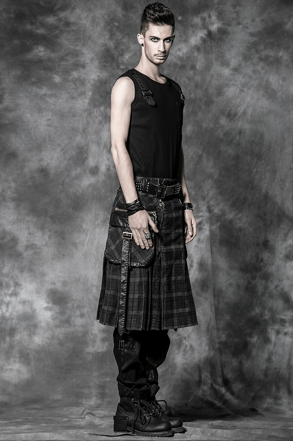 Hem and pleat detail of black tartan kilt showing structured construction and finishing