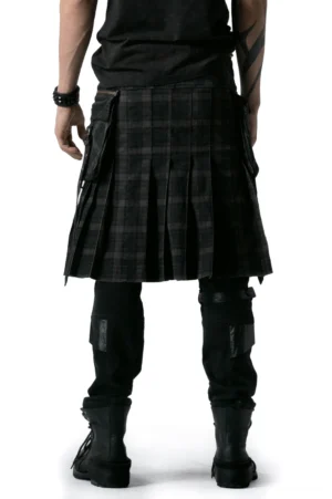 Gothic tartan tactical kilt rear view showing pleated skirt and side cargo pockets with combat boots