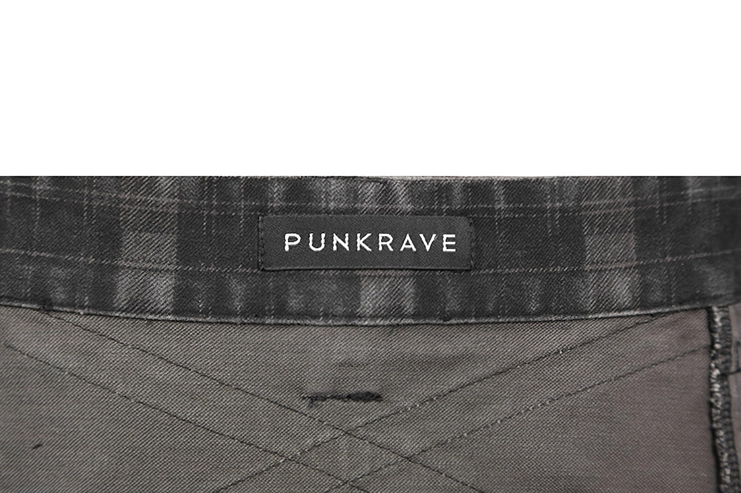 Flat lay overhead view of black tartan utility kilt showing complete design and proportions