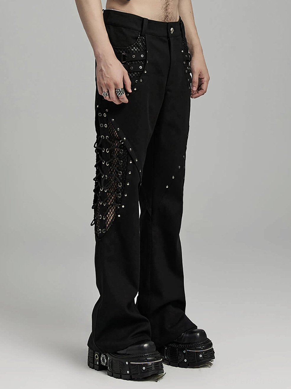Black twill fabric texture and metal rivet embellishments on gothic flare pants