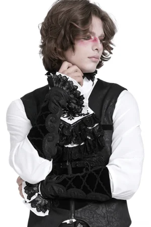 Black velvet gothic arm gauntlets with baroque lace-up lacing worn by male model with dramatic goth makeup, three-quarter view showing ruffled lace cuffs and embroidered details on studio background