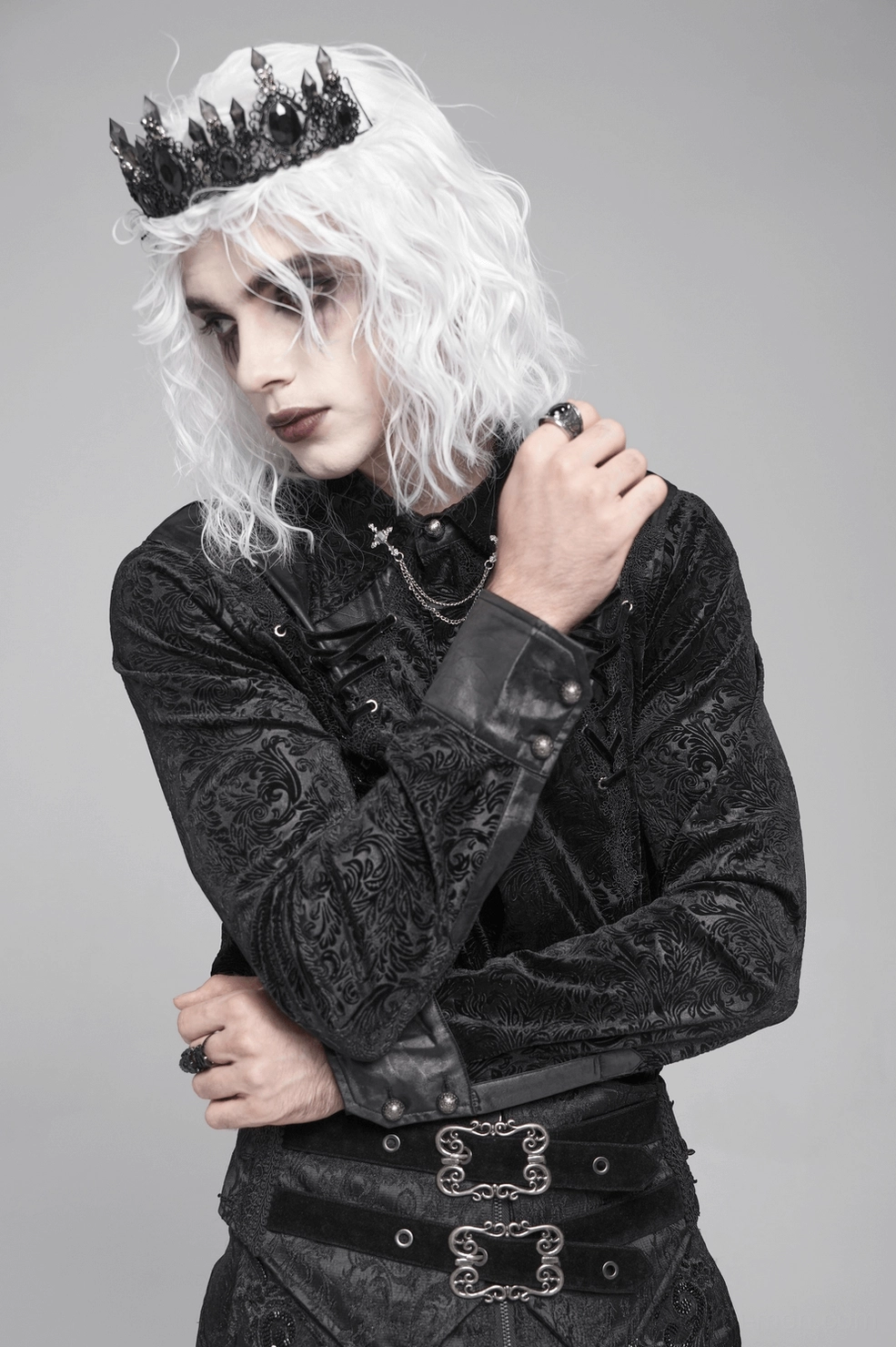 Detail shot of black gothic velvet shirt leather shoulder panel and embossed floral embroidery on upper body