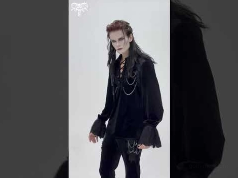 Side angle view of black velvet gothic shirt featuring chain accents and lace cuff details