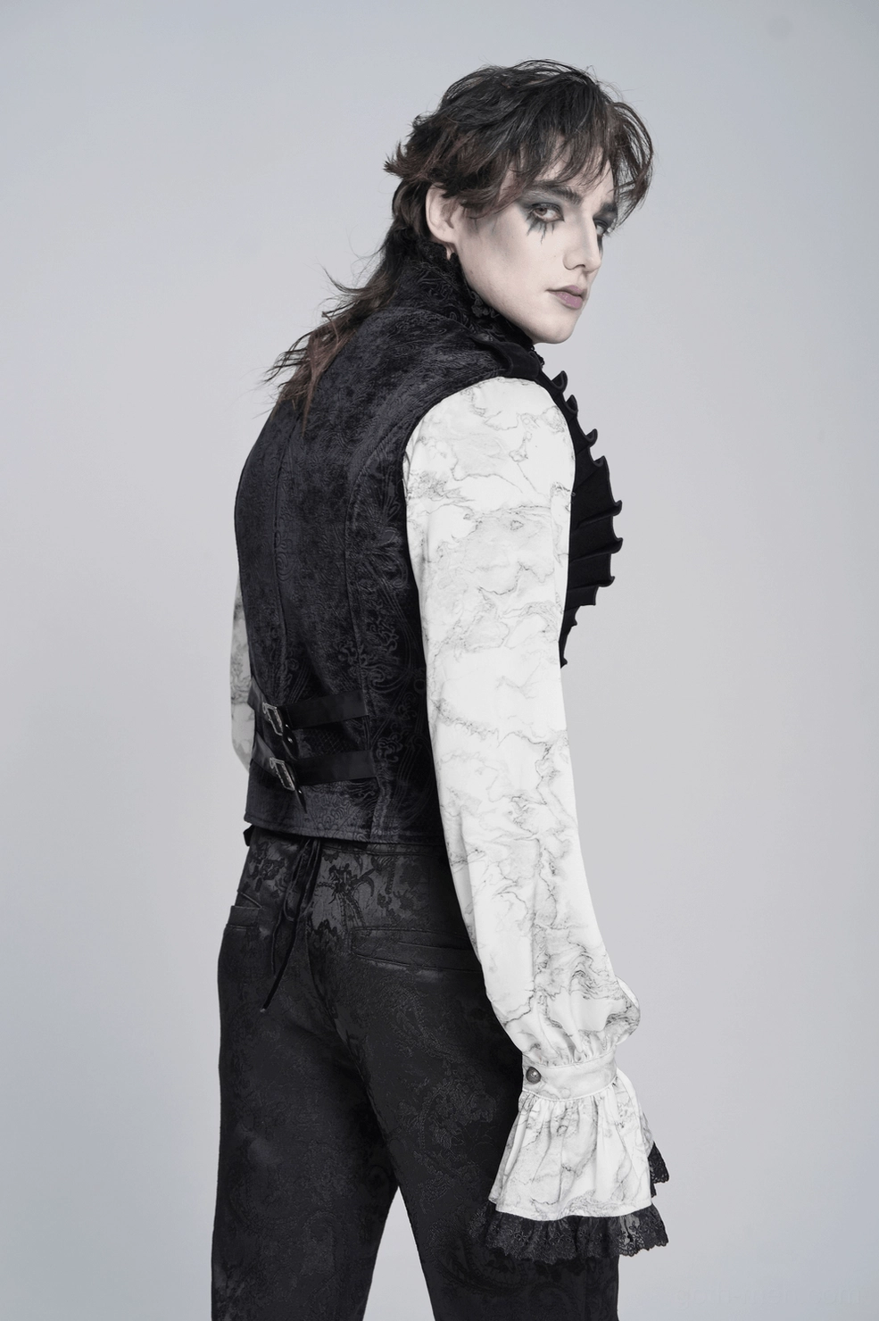 Full-length presentation of men's black velvet gothic waistcoat with high stand collar and ornate metal button accents