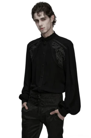 Black Victorian gothic embroidered shirt with lantern sleeves worn by male model, front three-quarter view showing ruffled collar and shoulder scroll embroidery