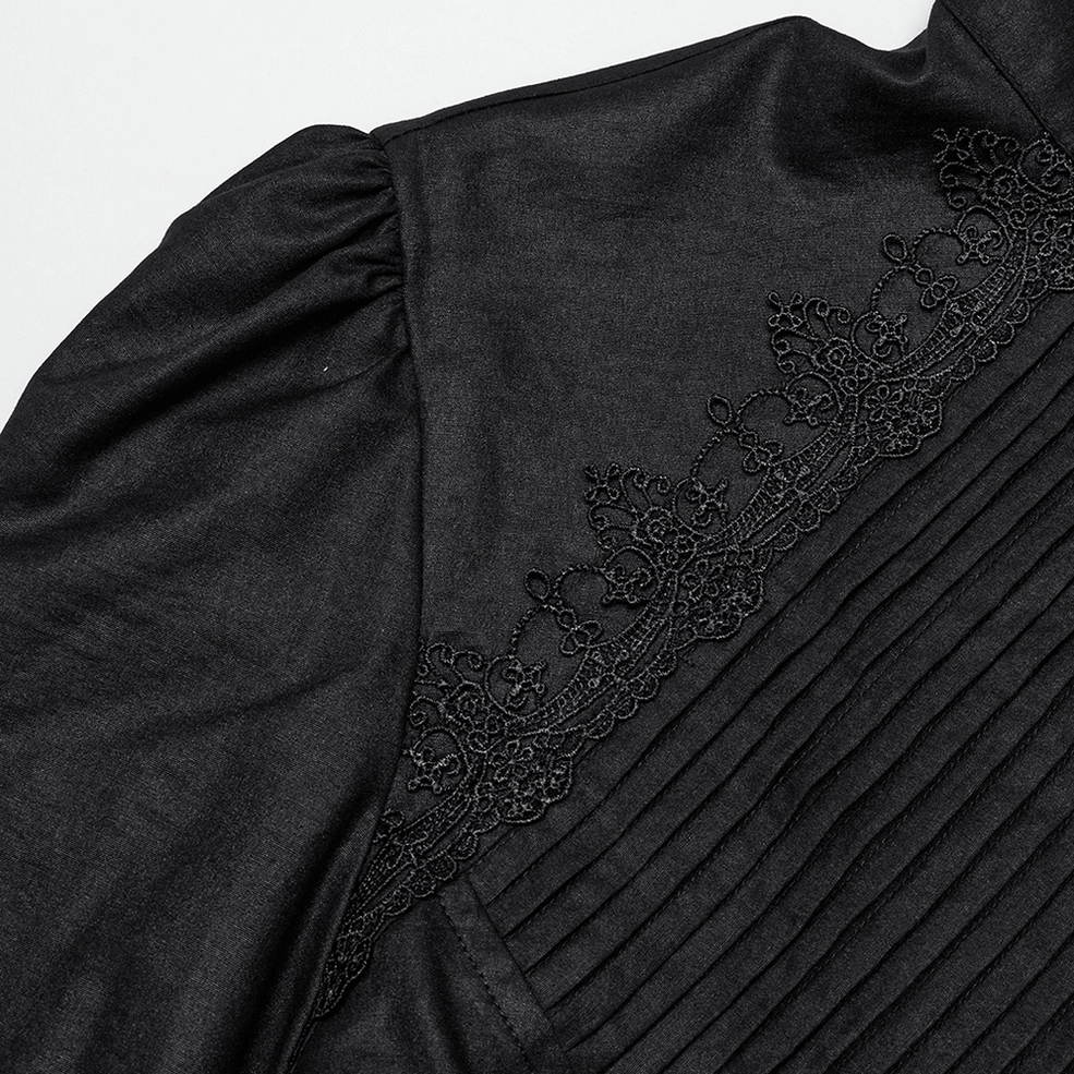 Close-up detail showing embroidered lace trim and pin-tuck pleats on black gothic shirt