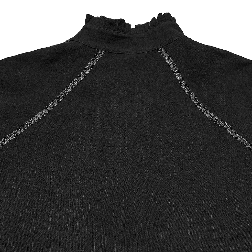 Close-up detail of black Victorian gothic shirt ruffled stand collar with embroidered seam trim and matte woven fabric texture