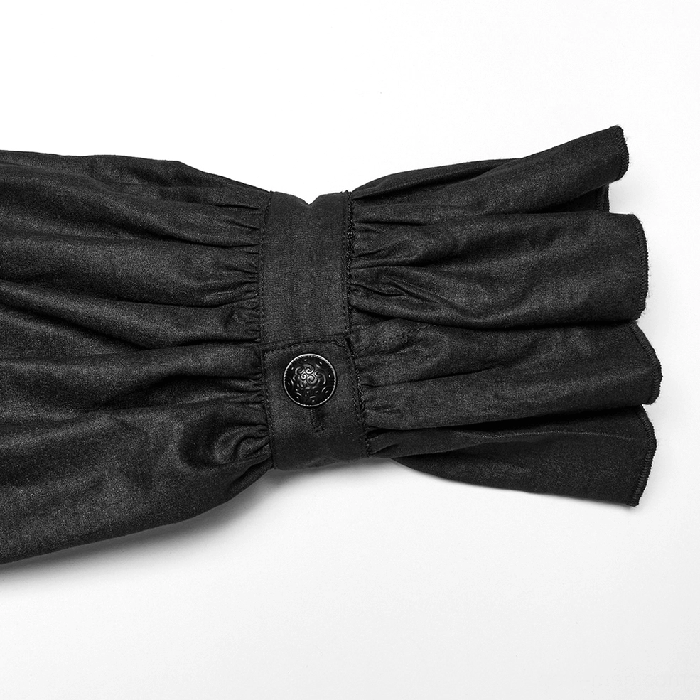 Close-up detail of ruffled cuff with vintage metal button on black victorian gothic shirt