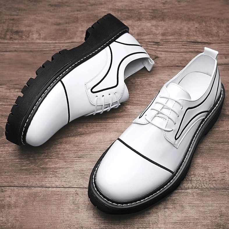 Black and white patent leather oxford platform shoes color blocking design flat lay overhead view