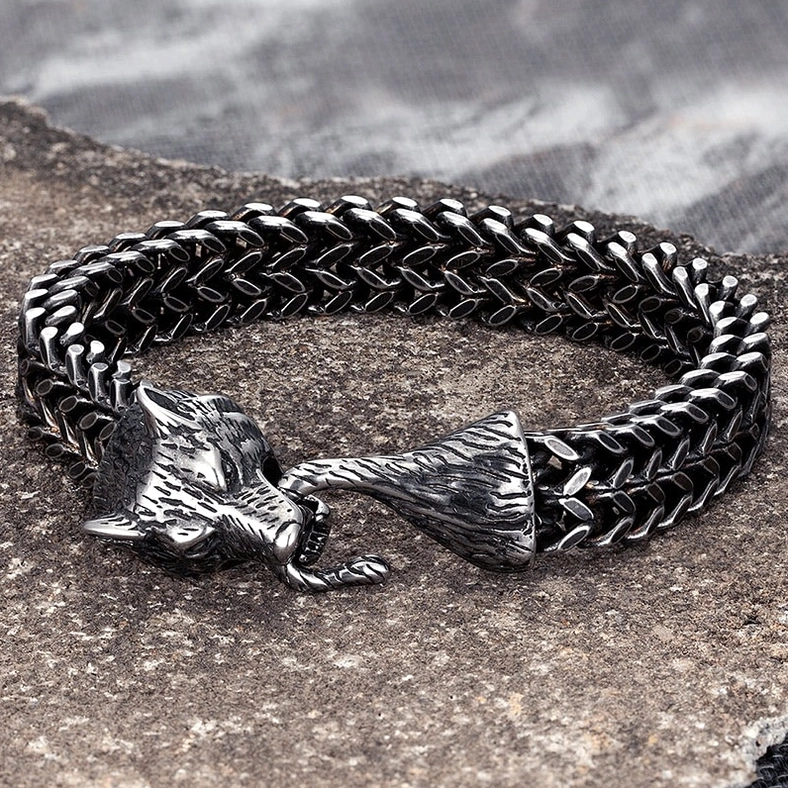 Wolf head gothic bracelet overhead view – detailed wheat-link chain and clasp on stone background