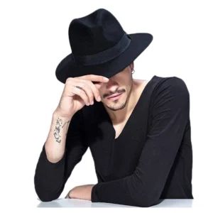 Black wool gothic fedora hat with wide brim and black ribbon band, worn by male model in front view on white studio background