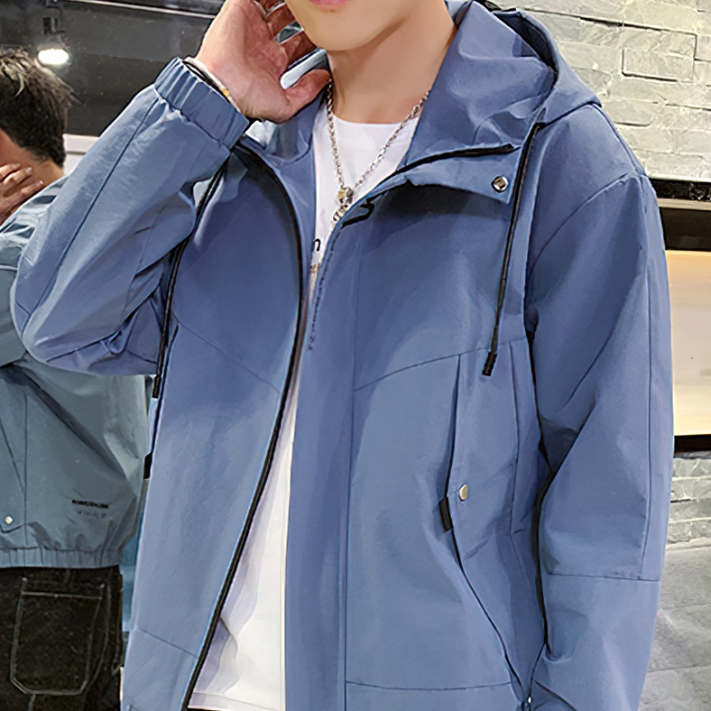 Blue hooded gothic men's cargo jacket close-up front zipper and drawstring hood detail on model