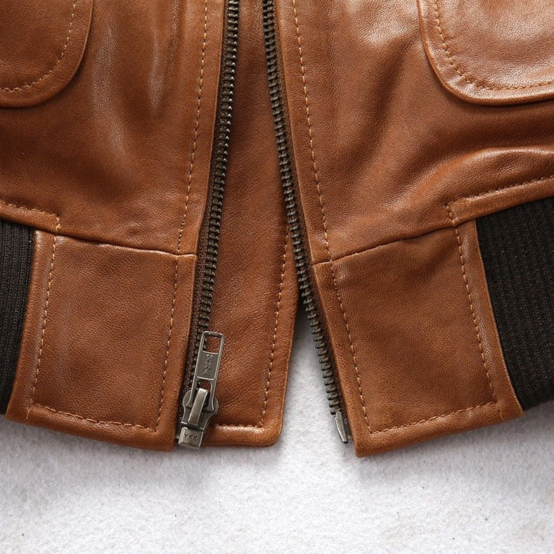 Metal front zipper close-up of gothic bomber jacket showing brown genuine lambskin leather material