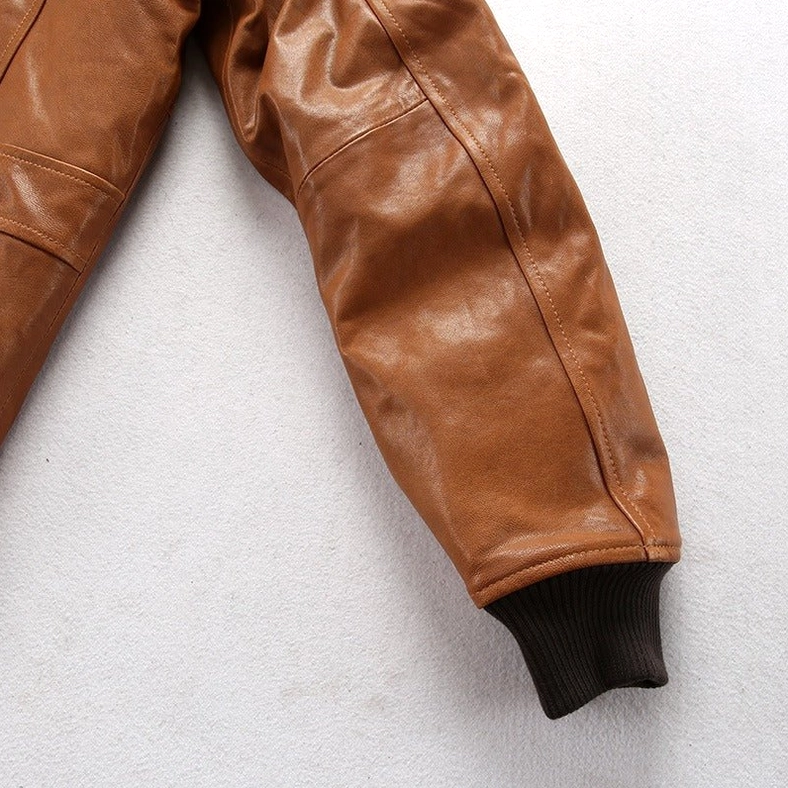 Lambskin bomber jacket sleeve close-up showing smooth brown leather texture and ribbed cuff detail