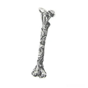 Bone pendant with embossed vine patterns and antique silver tone metal side profile detail shot