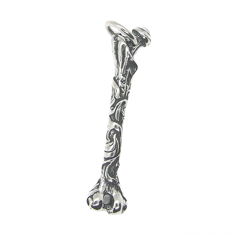 Bone pendant with embossed vine patterns and antique silver tone metal side profile detail shot