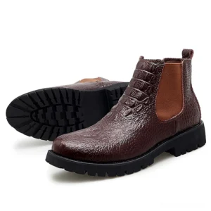 Brown crocodile embossed gothic chelsea ankle boots displaying rubber outsole and side profile with embossed leather detail