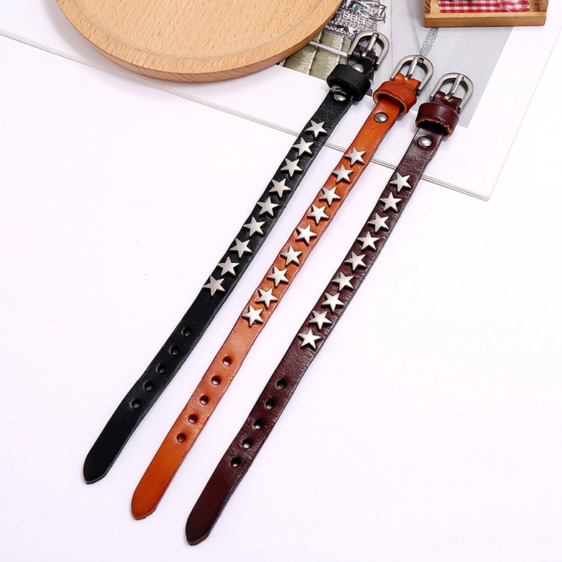 Brown distressed leather gothic bracelet with silver star embellishments and vintage character on styled table setting