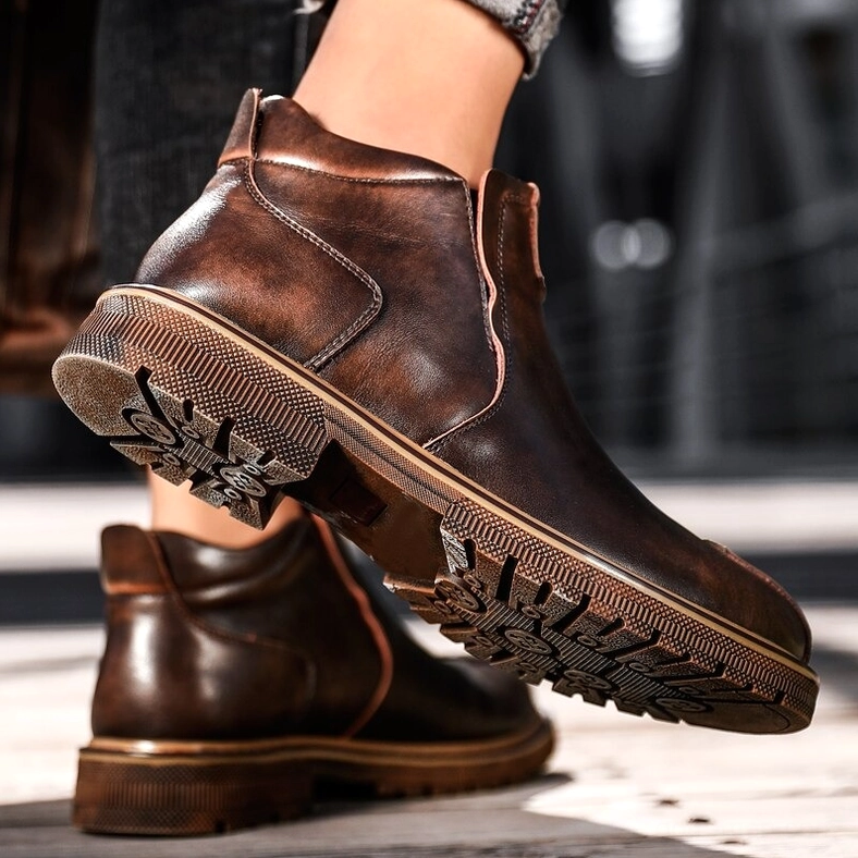 Brown leather gothic ankle boots for men, lower leg view showing polished finish and stitched sole detail