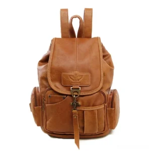Tan brown vintage leather backpack with embossed logo detail and antique metal hardware, dark academia style