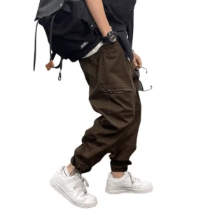 Brown gothic cargo harem pants side view on male model displaying zippered side pocket and dropped crotch design